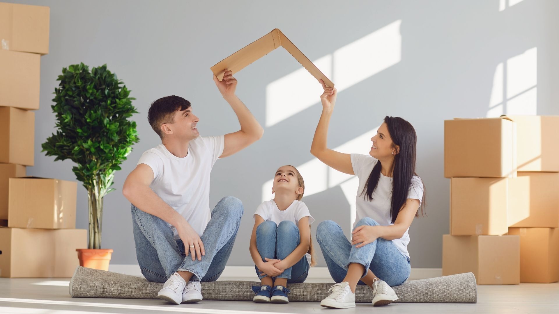 Family playing with cardboard in new home