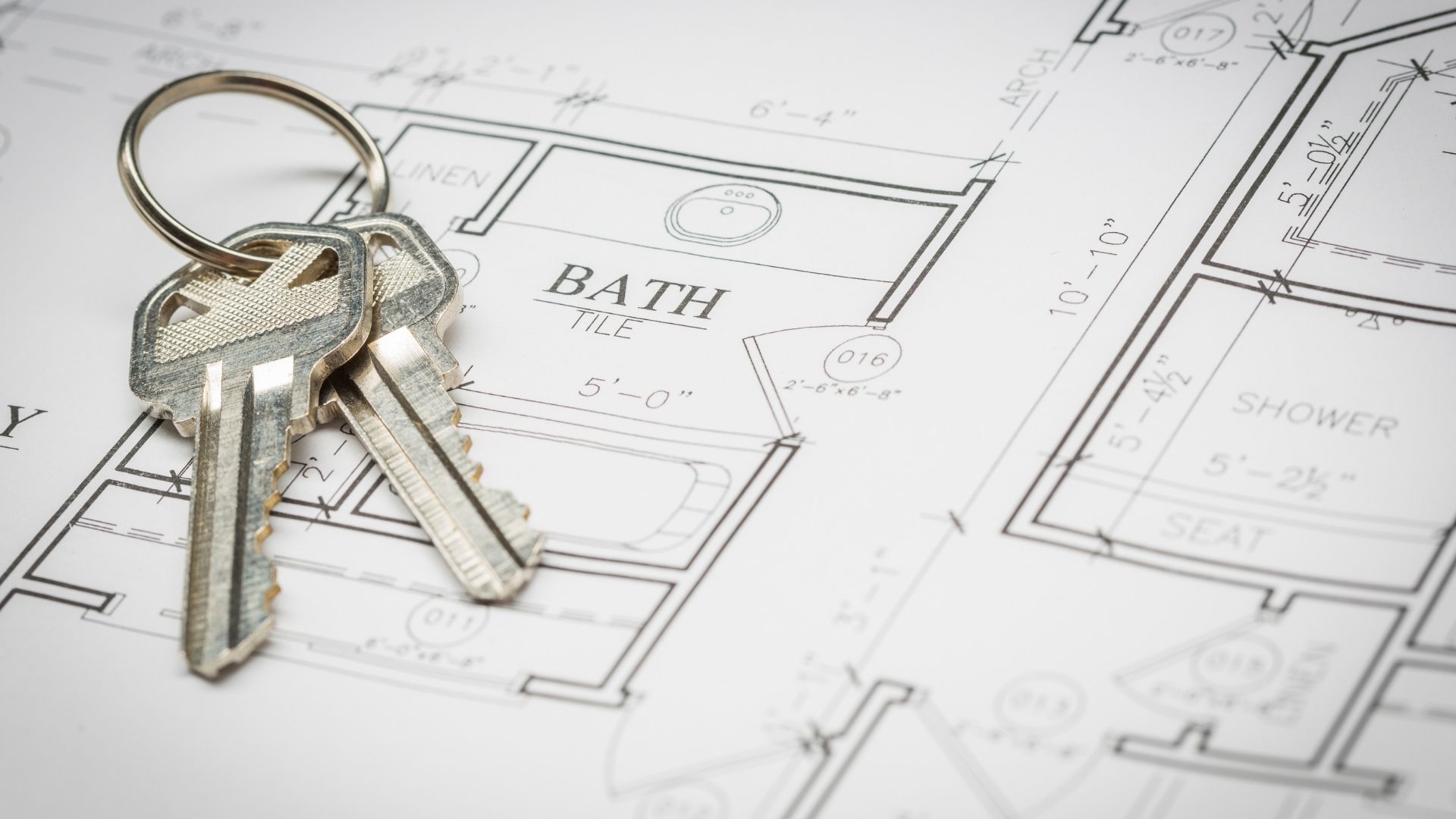 Keys on architectural blueprint for bathroom design