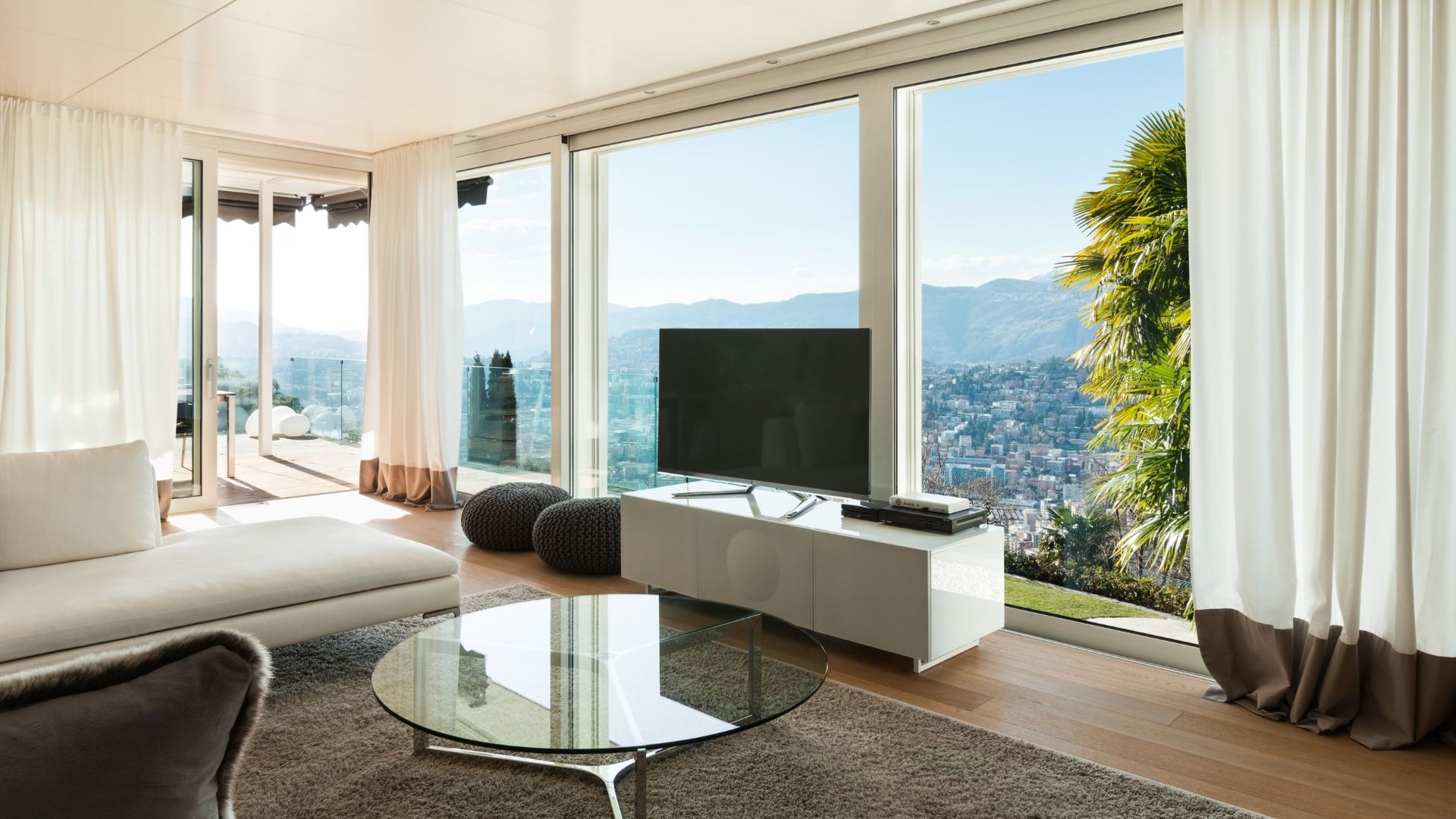 Modern living room with large windows and mountain view